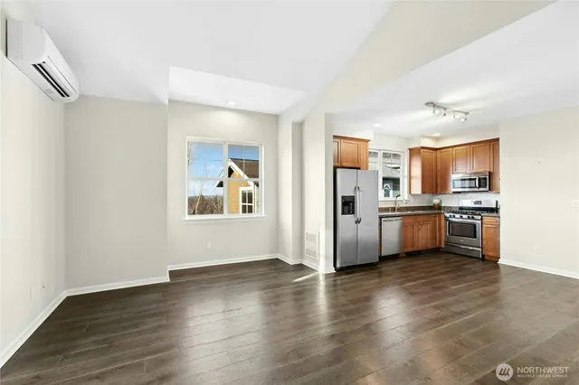 a view of a kitchen with a sink stove cabinets and empty room