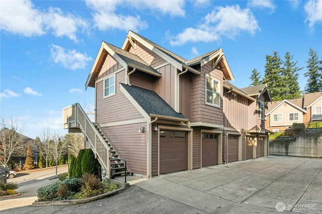 a blue and white house with a trees in front of it