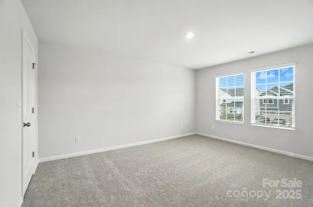 a view of a bedroom with wooden floor