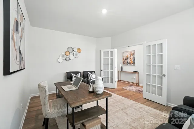 a dining room with furniture and wooden floor
