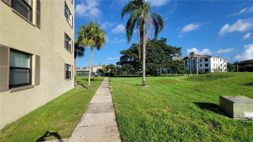 9273 Southwest 8th Street, Unit 109 Boca Raton, FL 33428 - Photo 11 of 22 a view of a backyard with palm trees