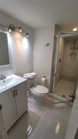 a bathroom with a sink mirror vanity and toilet