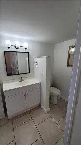a bathroom with a sink a toilet and mirror