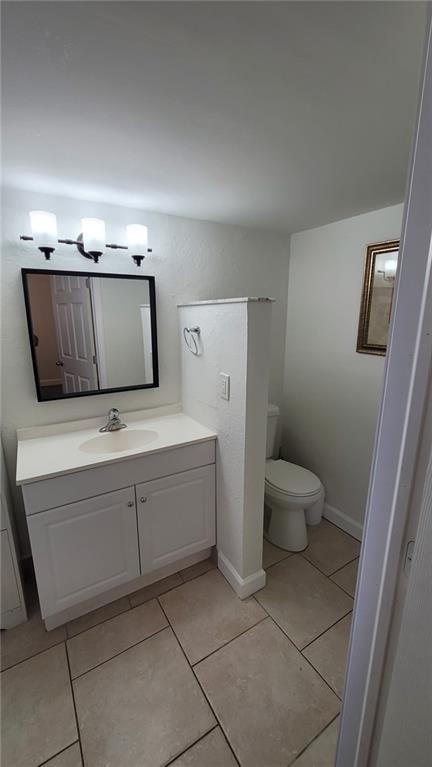 9273 Southwest 8th Street, Unit 109 Boca Raton, FL 33428 - Photo 8 of 22 a bathroom with a sink a toilet and mirror