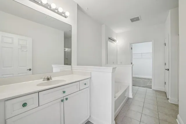 a bathroom with a sink a vanity and a mirror