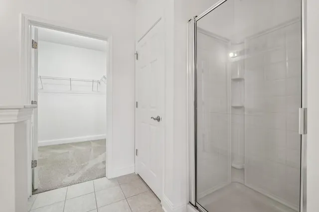 a bathroom with a shower and a glass door