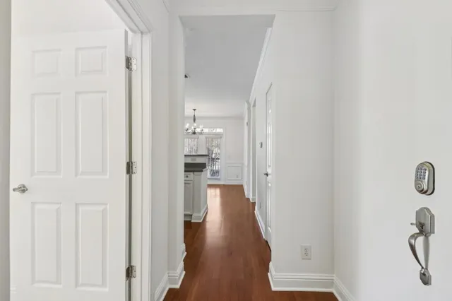 a view of a hallway with wooden floor and staircase