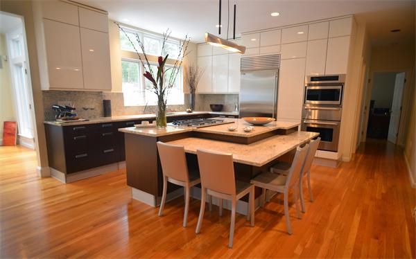 85 Westland Road Weston, MA 02493 - Photo 4 of 16 a kitchen with stainless steel appliances granite countertop a stove a refrigerator a sink a dining table and chairs with wooden floor