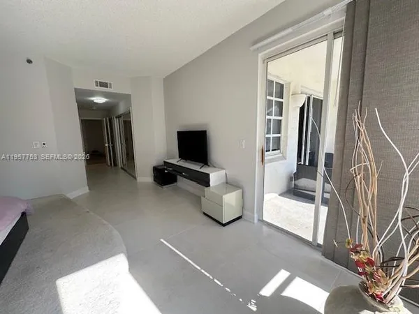 a view of a livingroom with furniture and a flat screen tv