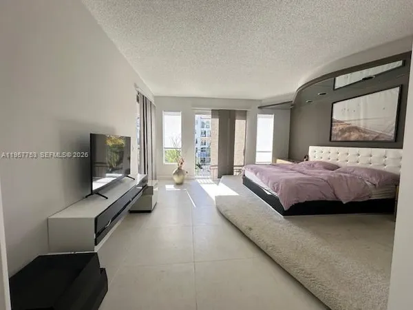 a view of a hallway with a livingroom and couch