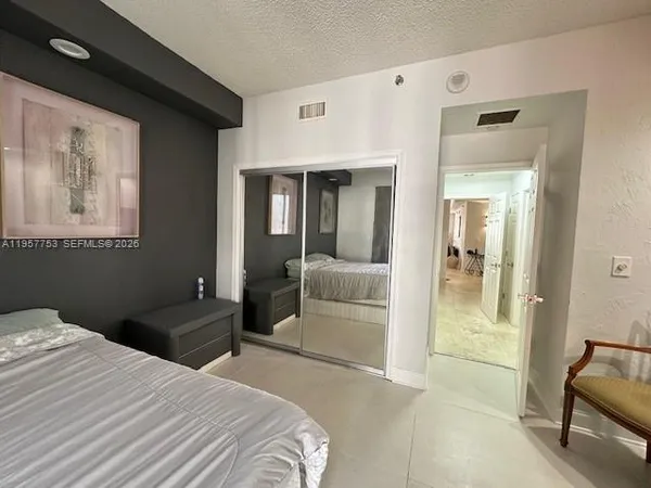 a bedroom with a bed and a mirror