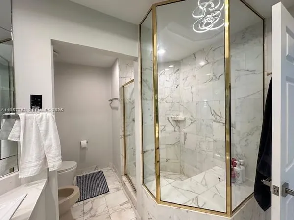 a bathroom with a glass door shower and a sink