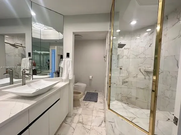 a bathroom with a double vanity sink toilet and shower