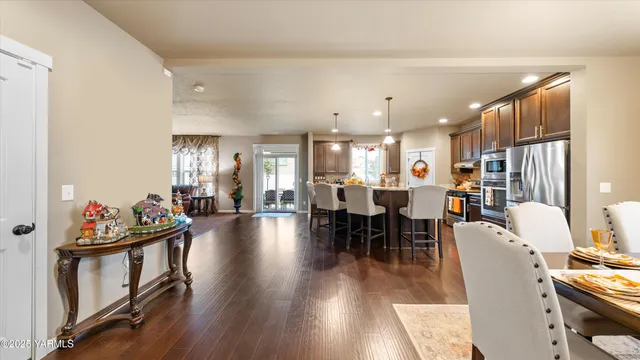 a living room with dining room and wooden floors