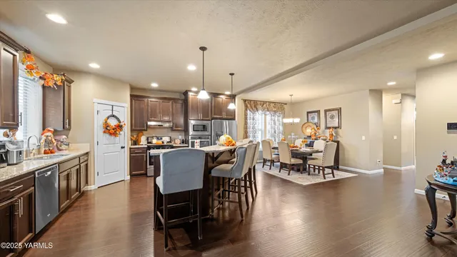 a dining room with furniture and wooden floor