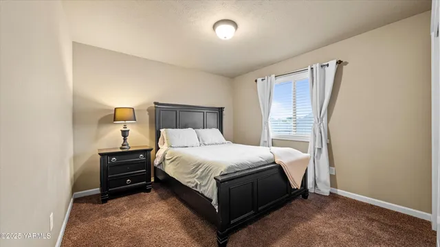 a bedroom with a bed and dresser