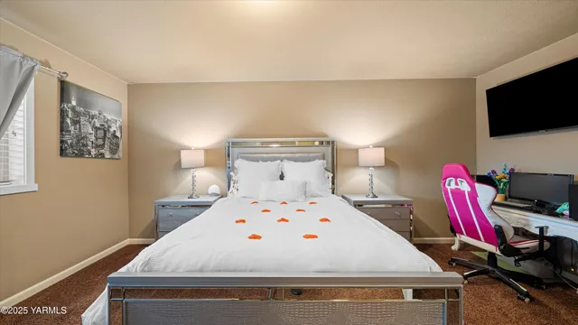 a bedroom with a bed and a flat screen tv