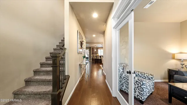 a view of entryway and hall with wooden floor