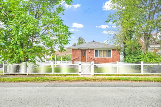 a view of a house with a swimming pool and a yard