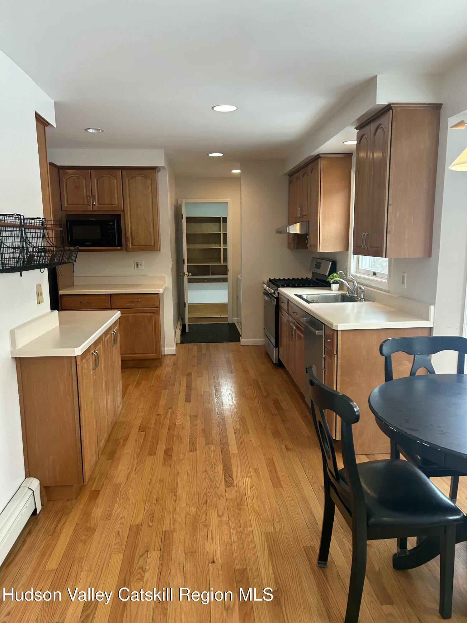 6 High Ridge Road New Paltz, NY 12561 - Photo 18 of 52 a kitchen with stainless steel appliances granite countertop a stove a sink a microwave a dining table and chairs