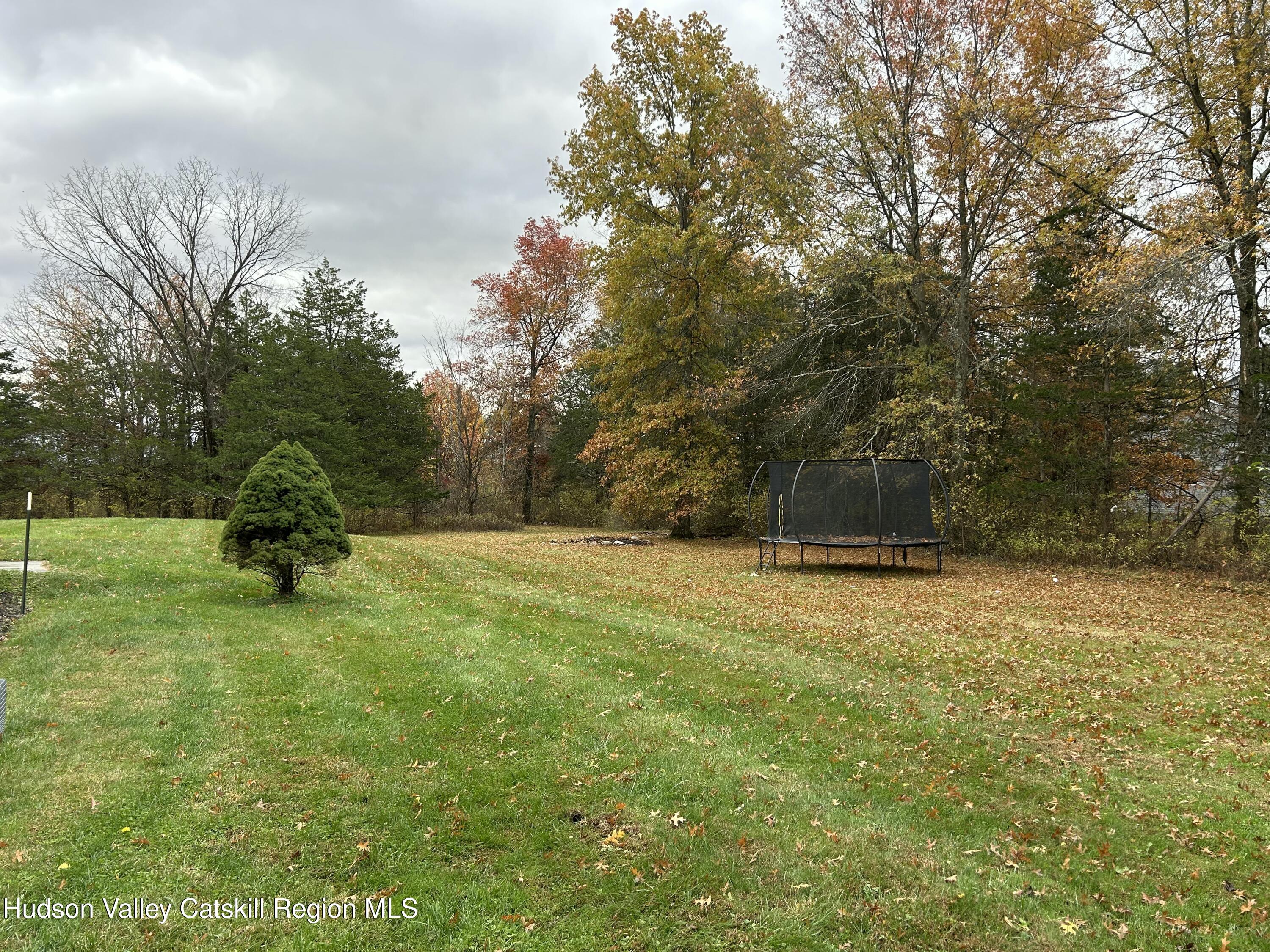 6 High Ridge Road New Paltz, NY 12561 - Photo 5 of 52 a backyard of a house with barbeque oven table and chairs
