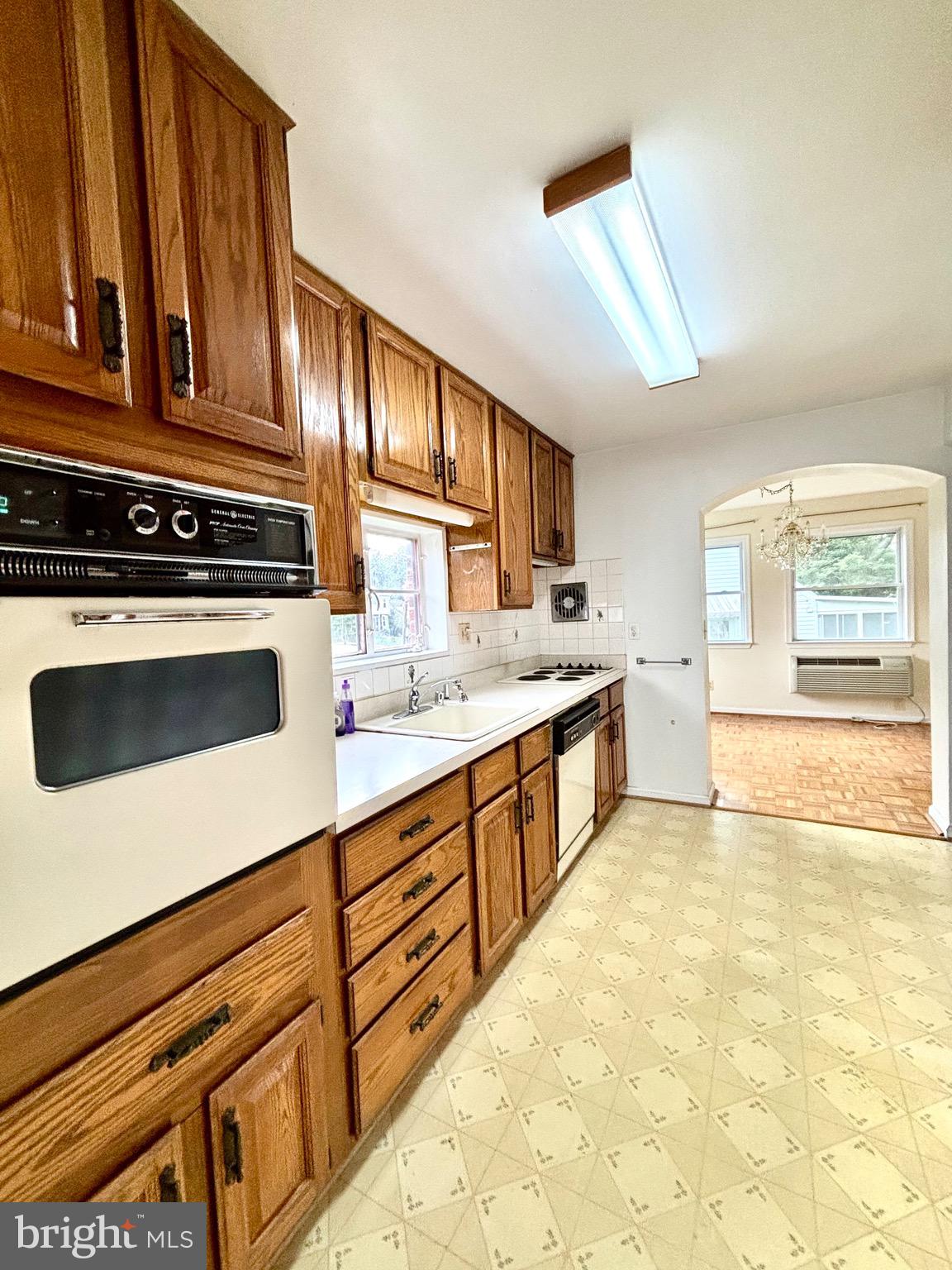 9815 Cottrell Terrace Silver Spring, MD 20903 - Photo 13 of 28 a kitchen with stainless steel appliances a stove a sink and a microwave