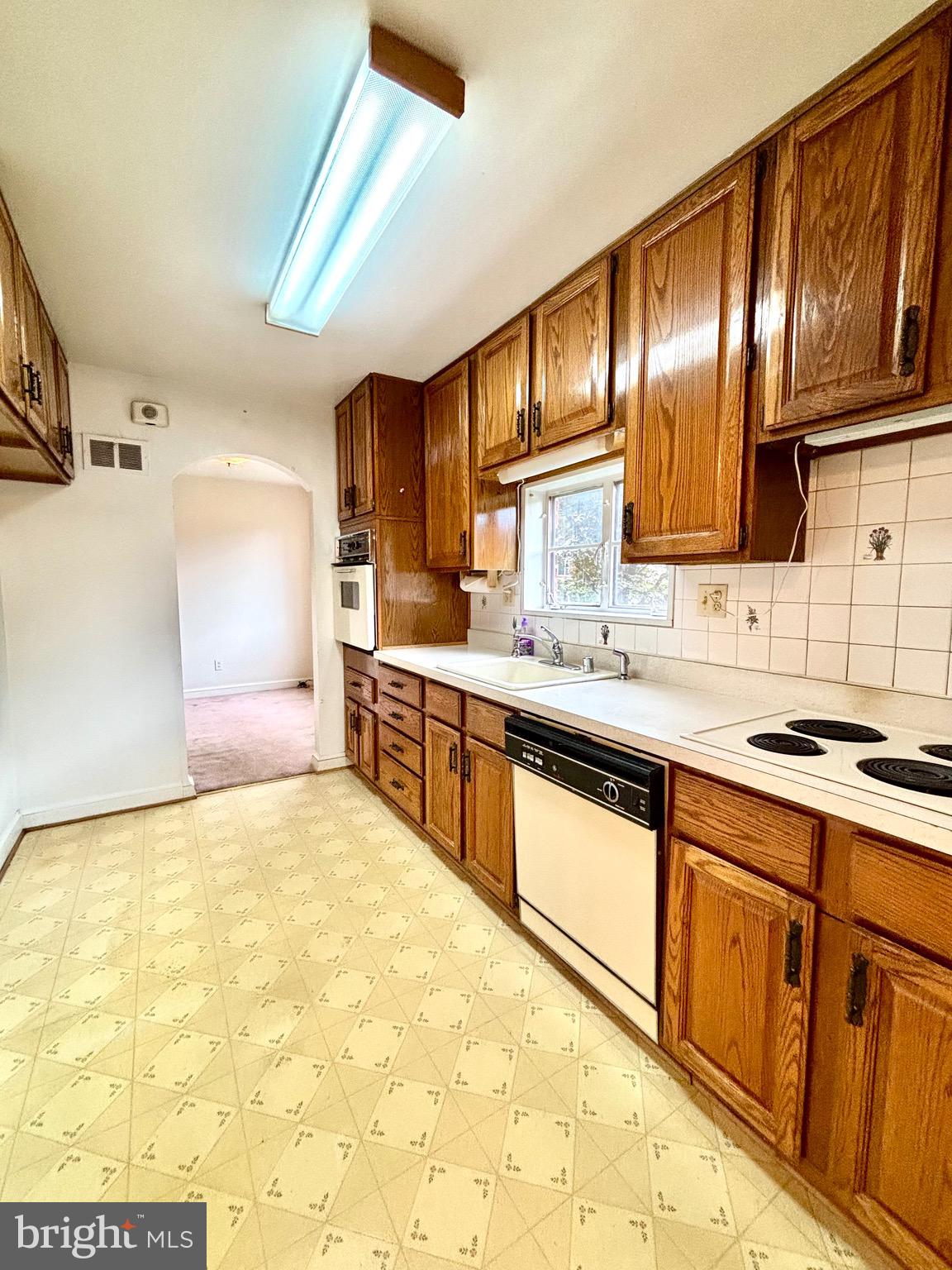 9815 Cottrell Terrace Silver Spring, MD 20903 - Photo 14 of 28 a kitchen with stainless steel appliances granite countertop a stove sink and cabinets
