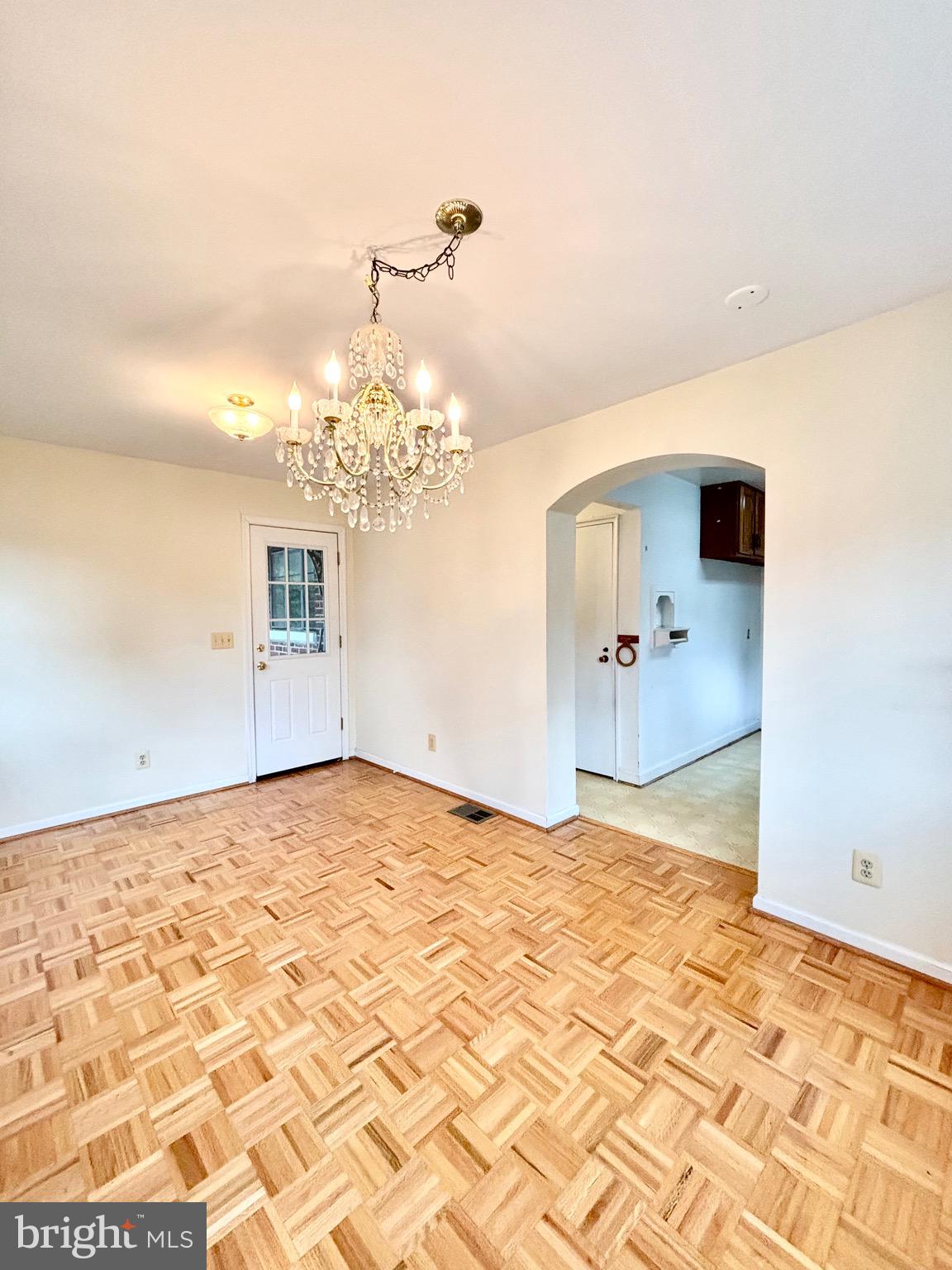 9815 Cottrell Terrace Silver Spring, MD 20903 - Photo 17 of 28 a view of a livingroom with wooden floor and a chandelier
