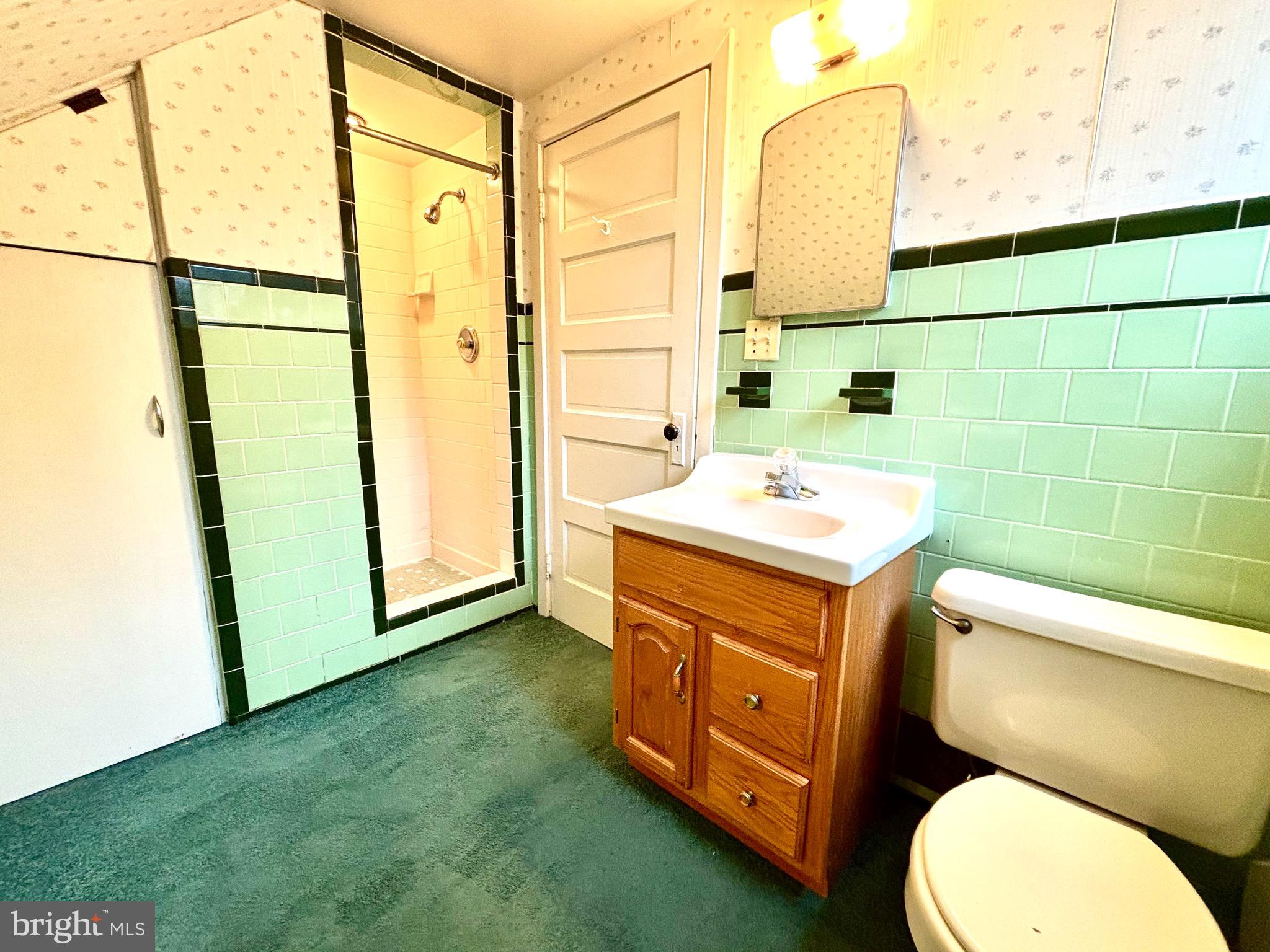 9815 Cottrell Terrace Silver Spring, MD 20903 - Photo 23 of 28 a bathroom with a sink mirror vanity and toilet