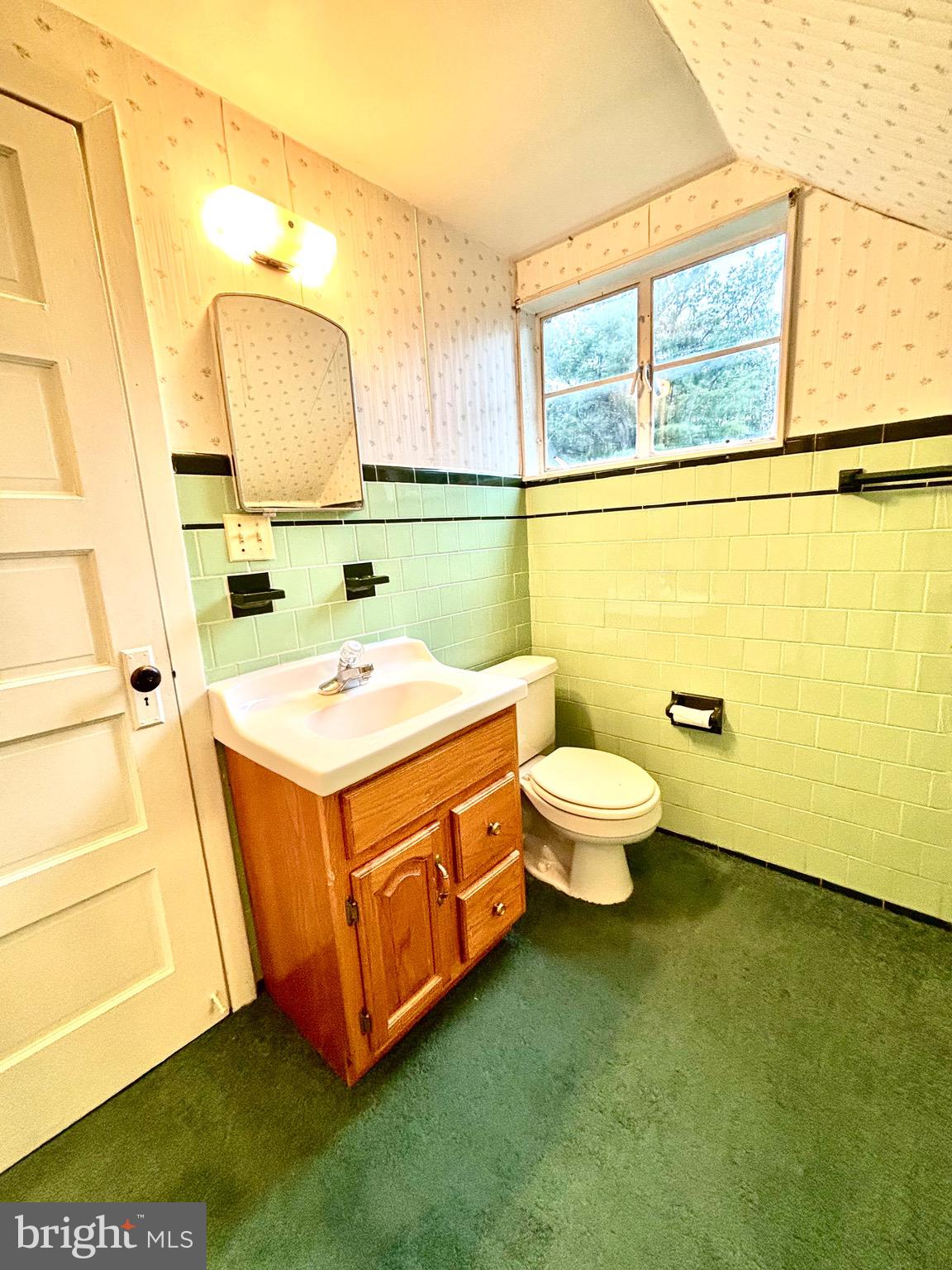 9815 Cottrell Terrace Silver Spring, MD 20903 - Photo 24 of 28 a bathroom with a sink mirror and toilet