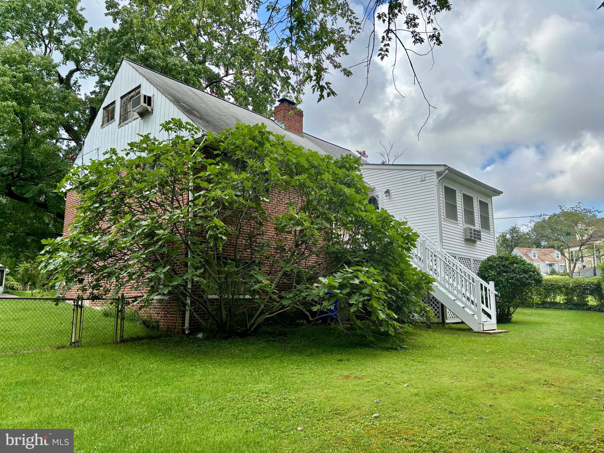 9815 Cottrell Terrace Silver Spring, MD 20903 - Photo 8 of 28 a yellow house sitting in the middle of a field