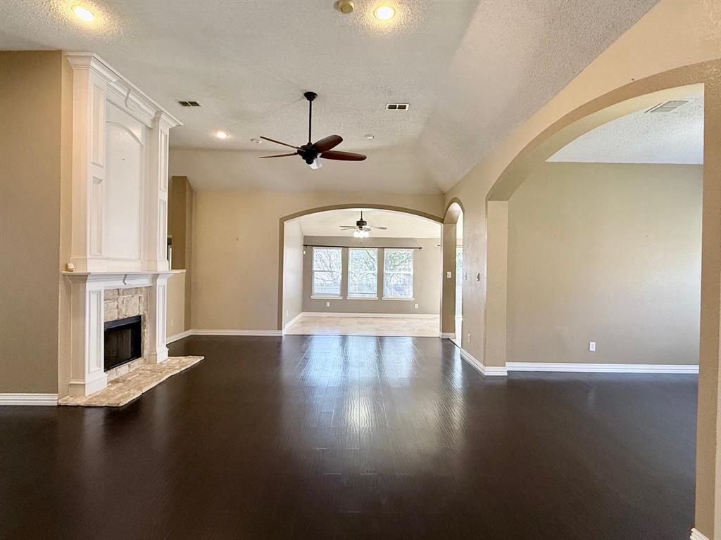 2607 Ridgeoak Trail Mansfield, TX 76063 - Photo 11 of 32 a view of an empty room with a fireplace and a window