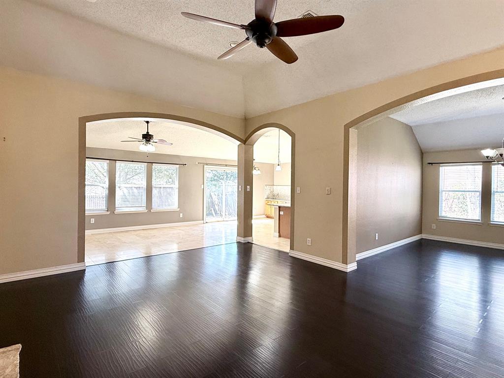 2607 Ridgeoak Trail Mansfield, TX 76063 - Photo 12 of 32 a view of an empty room with wooden floor and a window