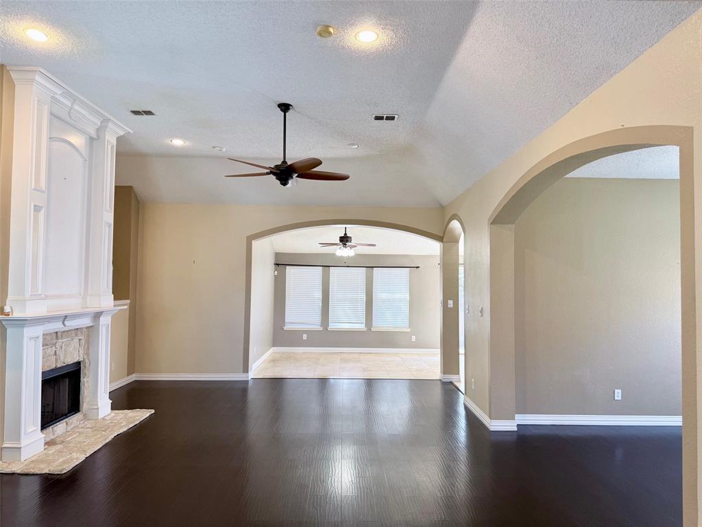 2607 Ridgeoak Trail Mansfield, TX 76063 - Photo 2 of 32 a view of livingroom with fireplace wooden floor and window