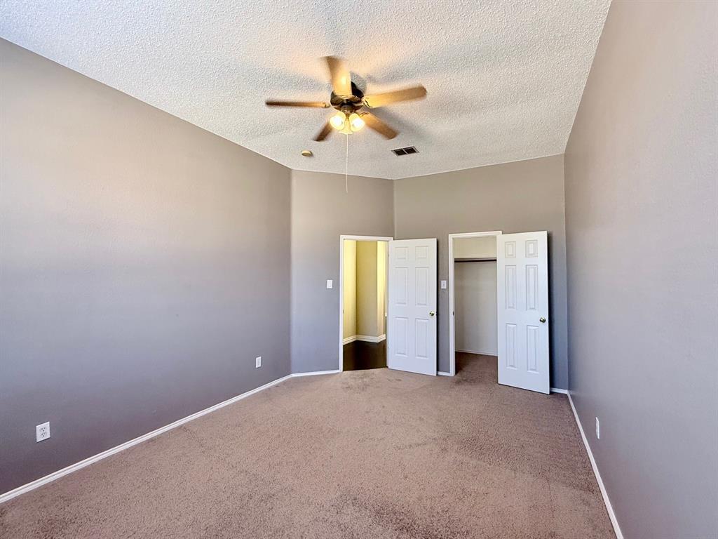 2607 Ridgeoak Trail Mansfield, TX 76063 - Photo 25 of 32 an empty room with closet and windows