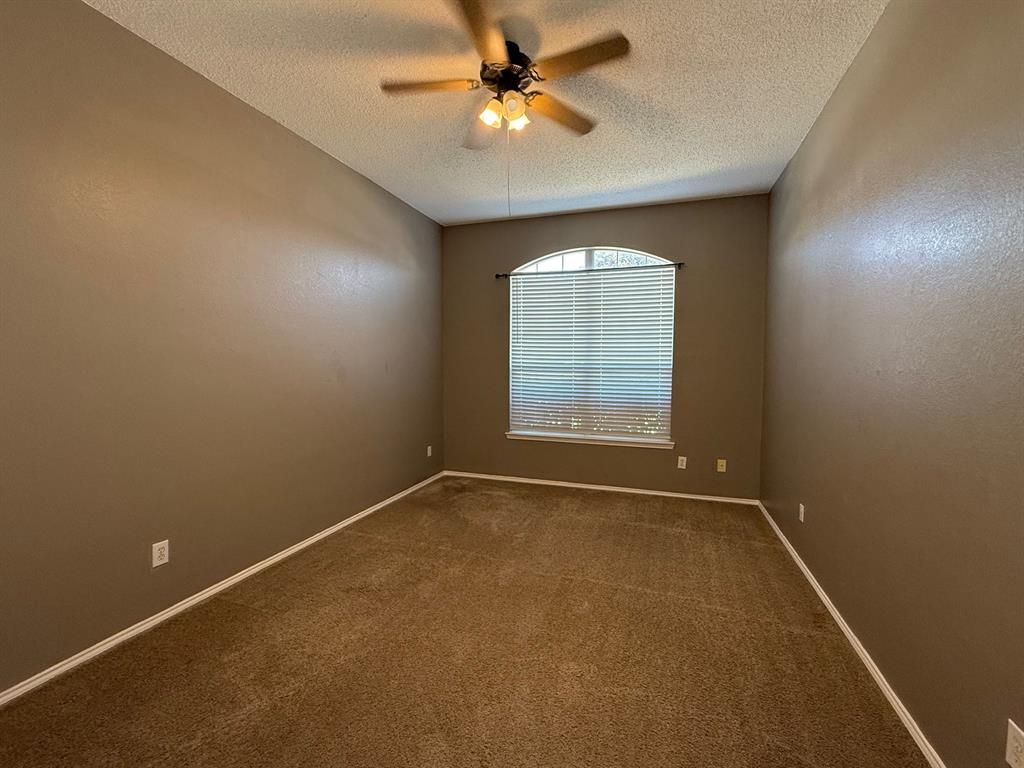 2607 Ridgeoak Trail Mansfield, TX 76063 - Photo 26 of 32 an empty room with windows and ceiling fan