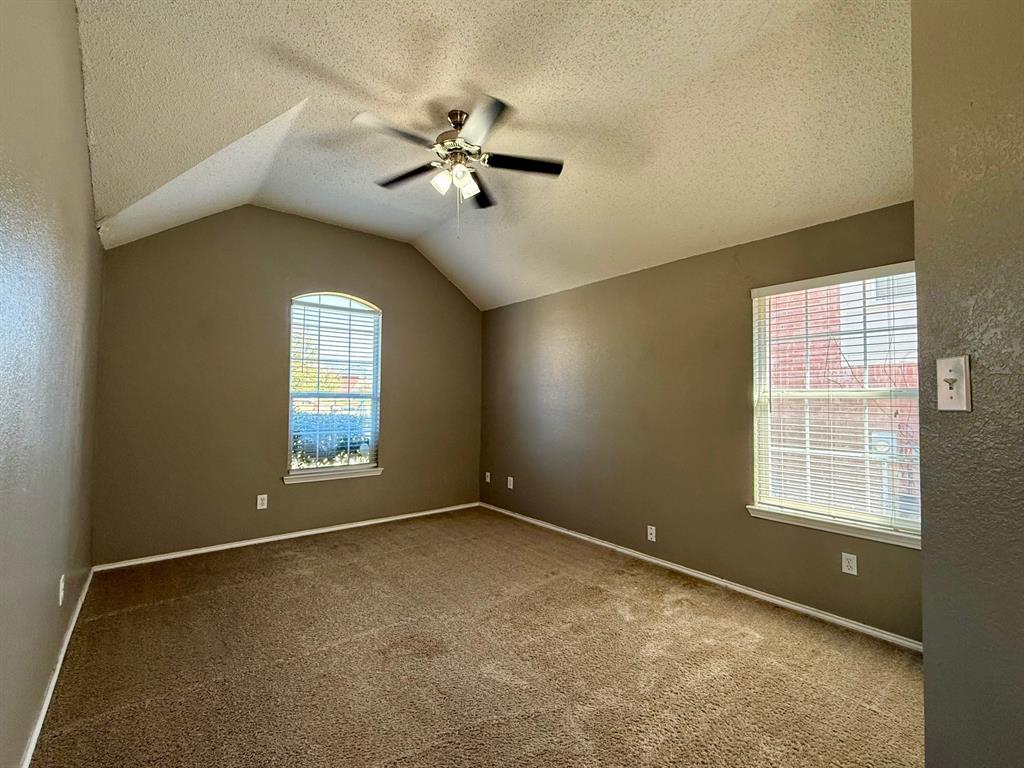 2607 Ridgeoak Trail Mansfield, TX 76063 - Photo 27 of 32 an empty room with windows and chandelier fan
