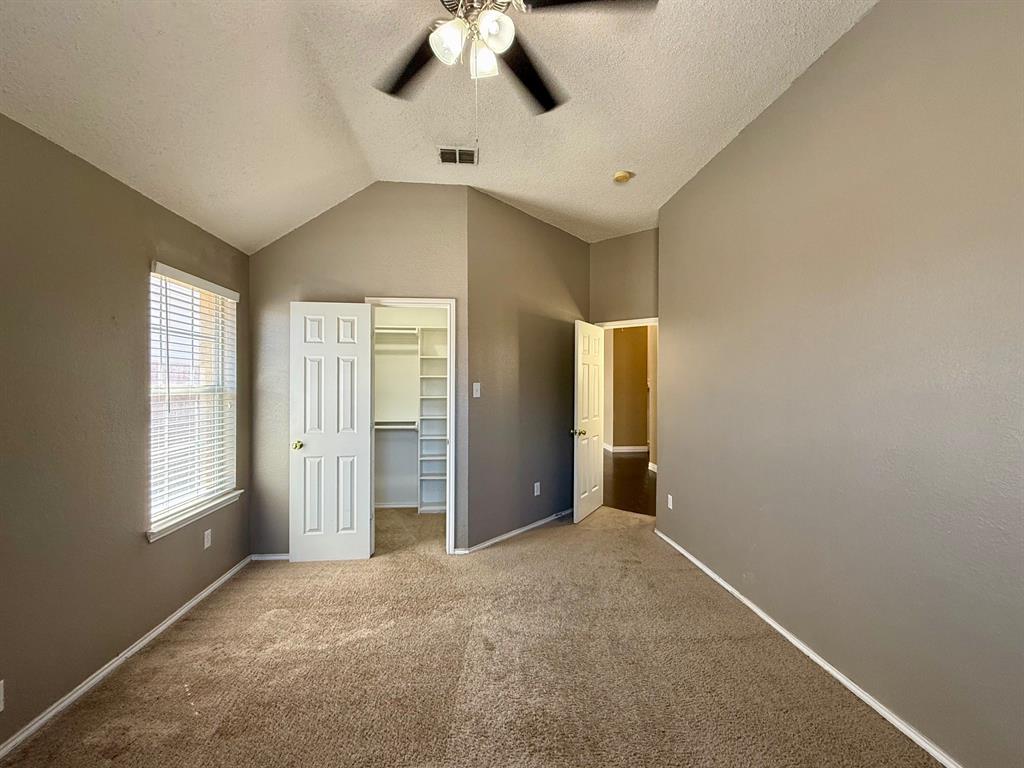 2607 Ridgeoak Trail Mansfield, TX 76063 - Photo 28 of 32 an empty room with windows and chandelier fan