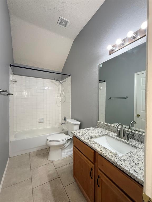 2607 Ridgeoak Trail Mansfield, TX 76063 - Photo 30 of 32 a bathroom with a granite countertop sink toilet a large mirror a shower and vanity