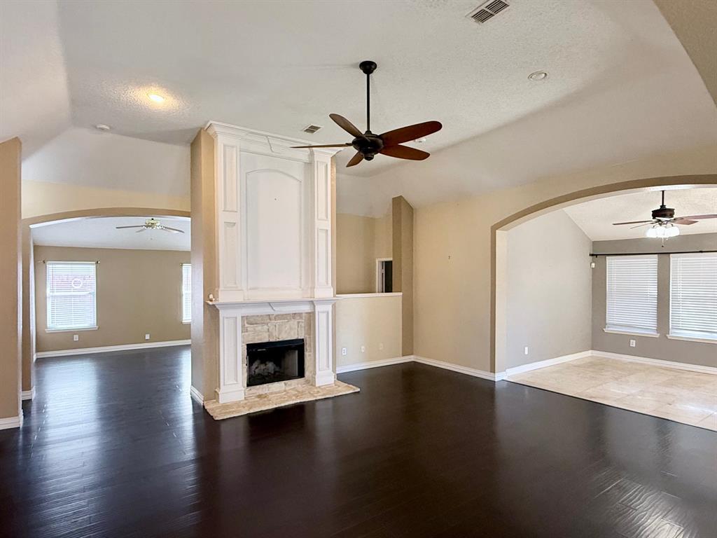 2607 Ridgeoak Trail Mansfield, TX 76063 - Photo 4 of 32 a view of empty room with wooden floor and fireplace