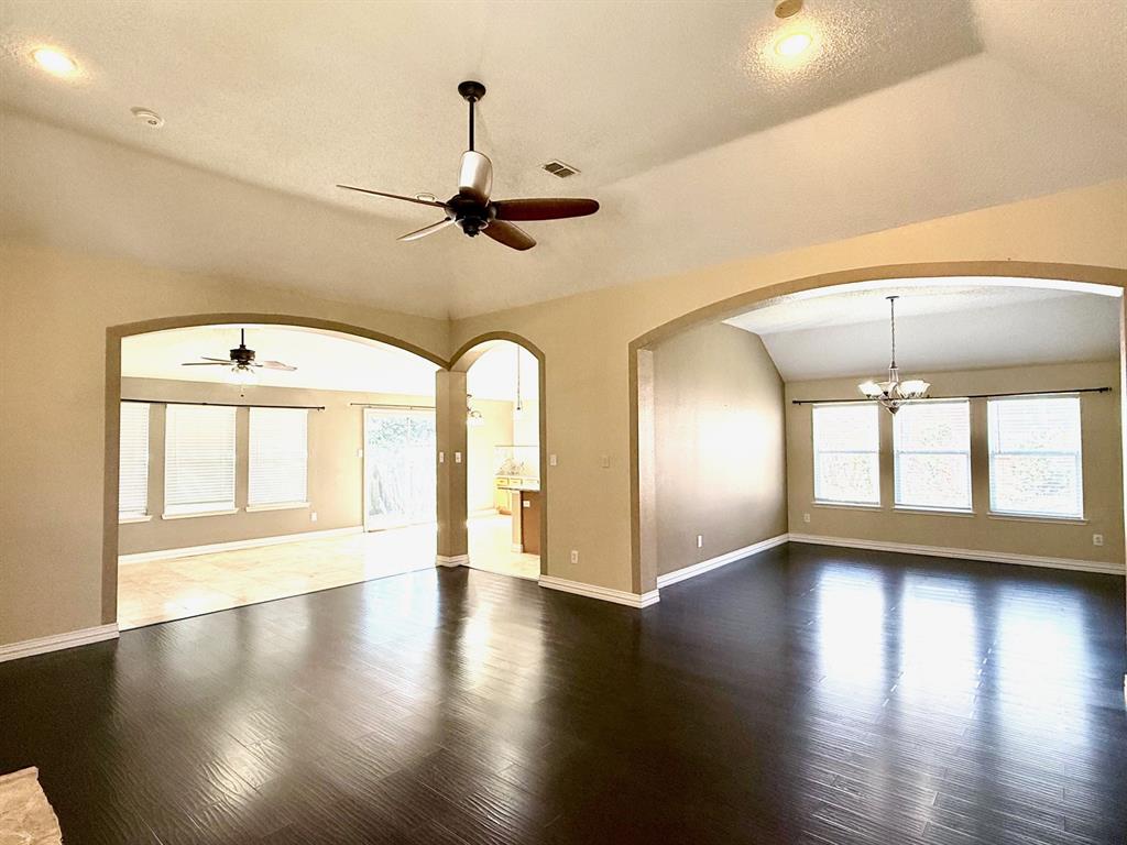 2607 Ridgeoak Trail Mansfield, TX 76063 - Photo 5 of 32 an empty room with wooden floor fan and windows
