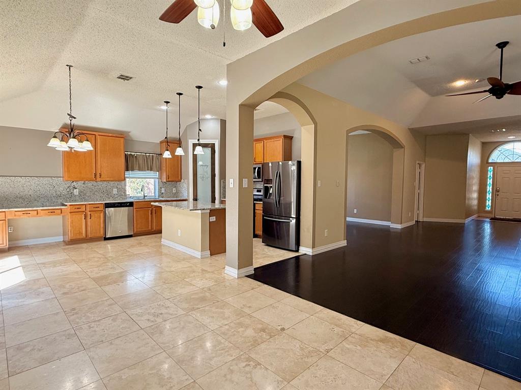 2607 Ridgeoak Trail Mansfield, TX 76063 - Photo 6 of 32 a large kitchen with cabinets and stainless steel appliances