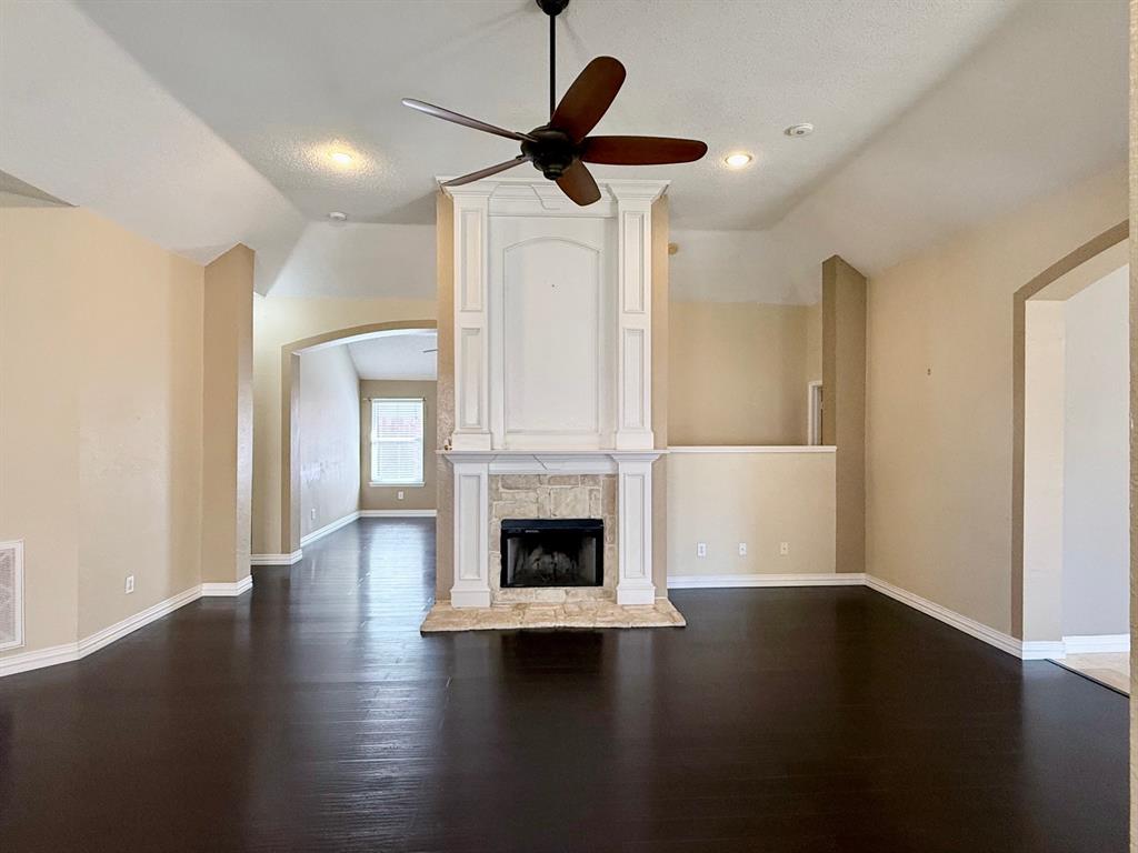 2607 Ridgeoak Trail Mansfield, TX 76063 - Photo 9 of 32 a living room with wooden floors and fireplace