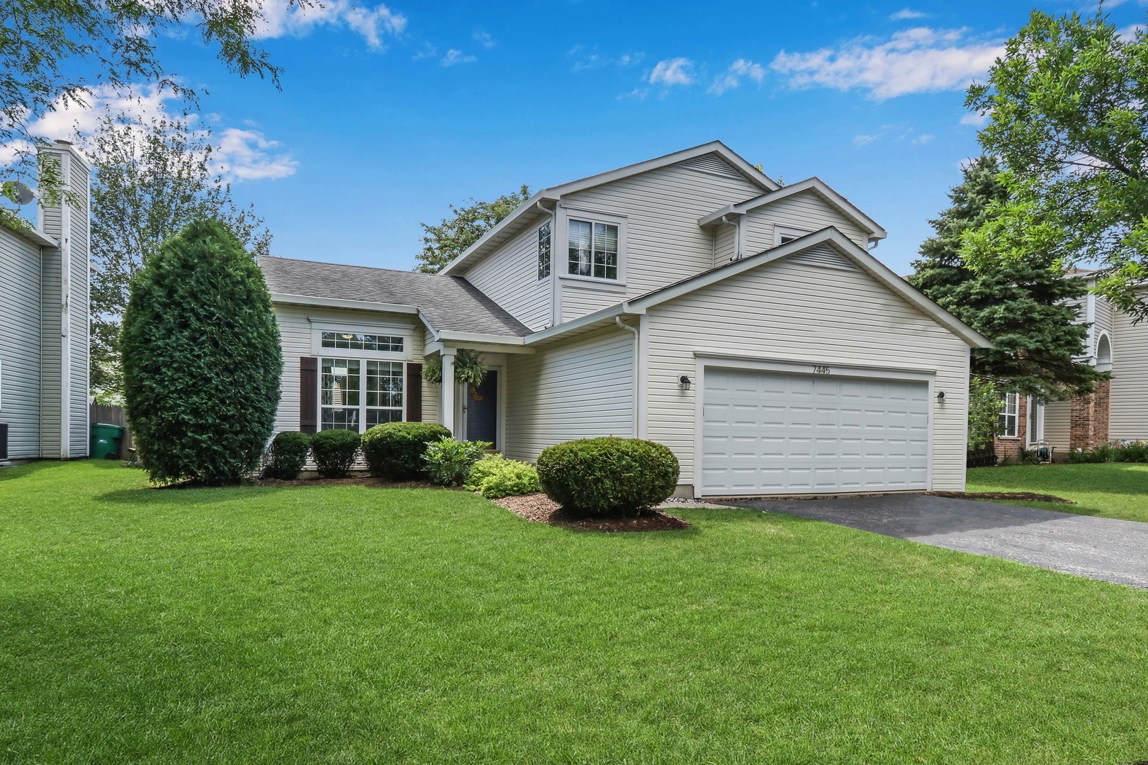 7445 Inglenook Lane Gurnee, IL 60031 - Photo 1 of 26 a front view of a house with a garden and yard
