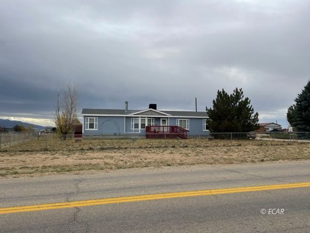 953 Spring Valley Parkway Spring Creek, NV 89815 - Photo 2 of 17 a view of a house with a yard