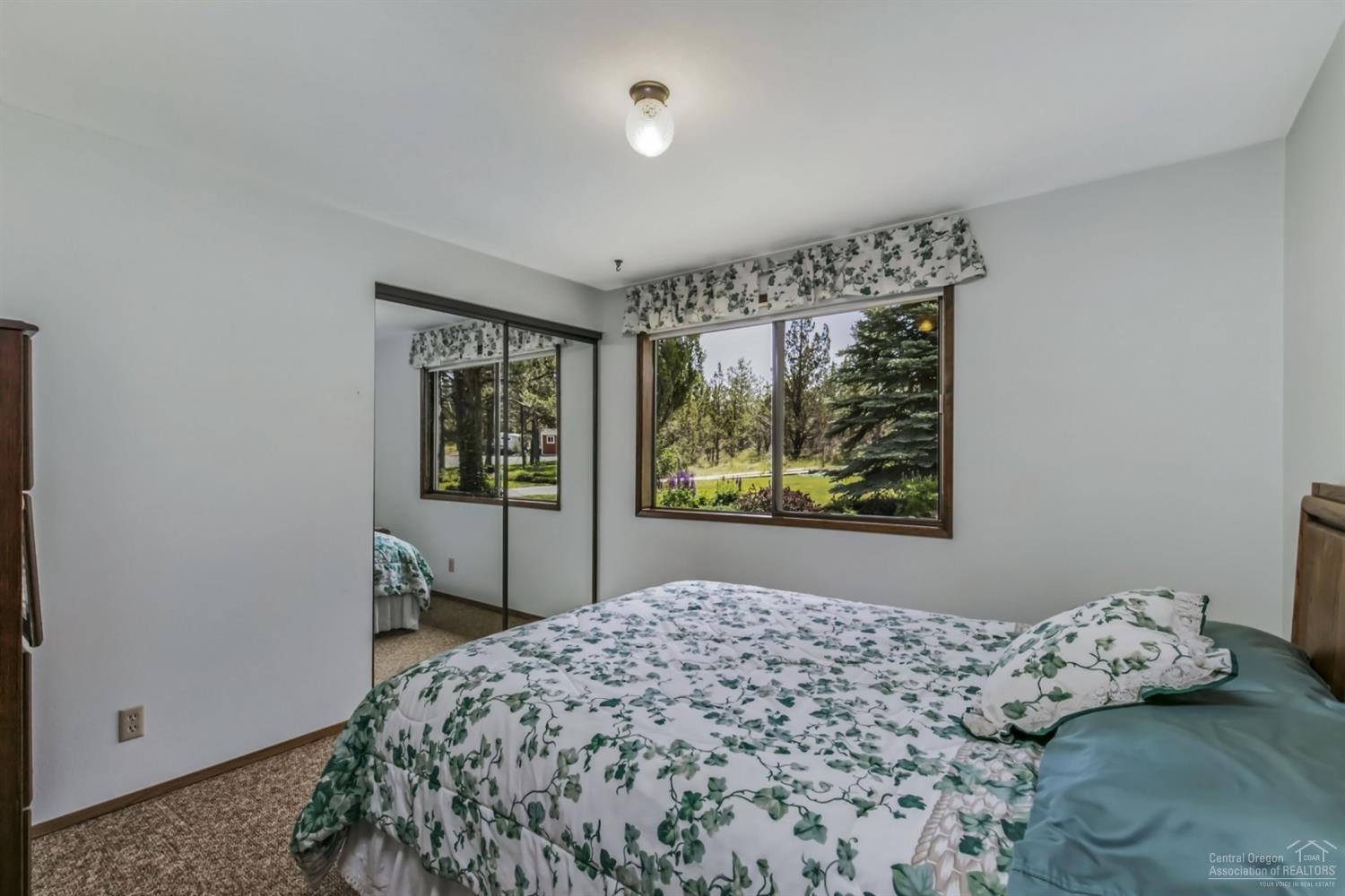 19435 Dayton Road Bend, OR 97703 - Photo 11 of 25 a bedroom with a bed and a window