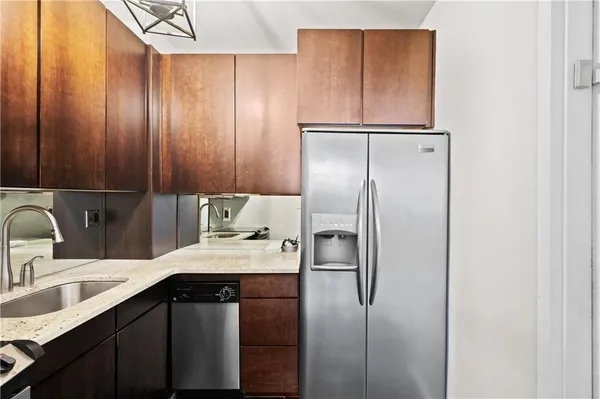 a kitchen with a sink refrigerator and cabinets