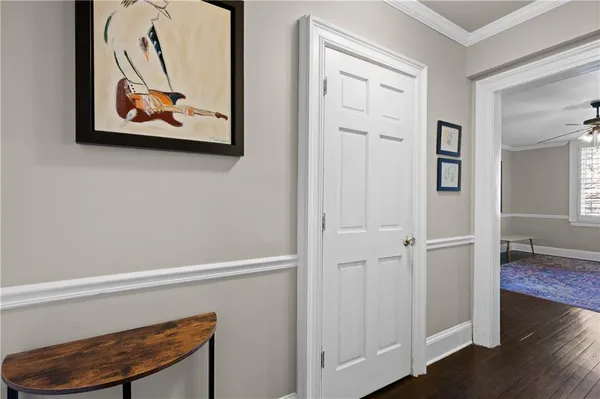 a view of a hallway with paintings on the wall