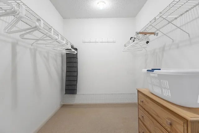 a spacious bedroom with a bed and large windows