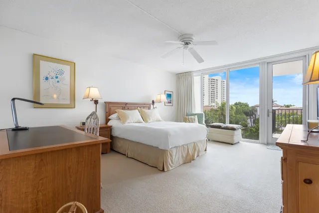 a bedroom with bed and a chandelier